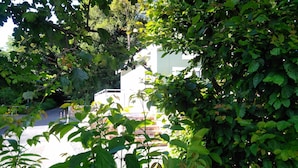 A view of a building partially obscured by dense foliage. - mit Grill in Bad Marienberg by Interhome (Bad Marienberg)