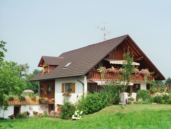 A traditional chalet with a sloped roof, wooden balconies, and a well-maintained garden. - "Säntisblick" by Interhome (Hergensweiler)