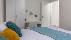 A bedroom with a bed, a wardrobe, a desk, and a door. - Moderne Wohnung in Crikvenica mit schöner Terrasse by Interhome (Crikvenica)