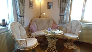 A cozy room with a sofa, two armchairs, and a small round table. - FeWo Bärli by Interhome (Bad Bayersoien)