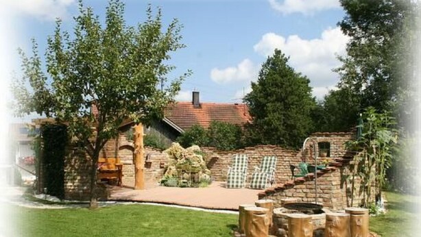 A rustic stone building with a brick pathway leading to a wooden bench. - FeWo Bärli by Interhome (Bad Bayersoien)