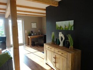 A room with a wooden cabinet, a desk, and a painting on the wall. - in Klein Meckelsen mit Garten by Interhome (Klein Meckelsen)