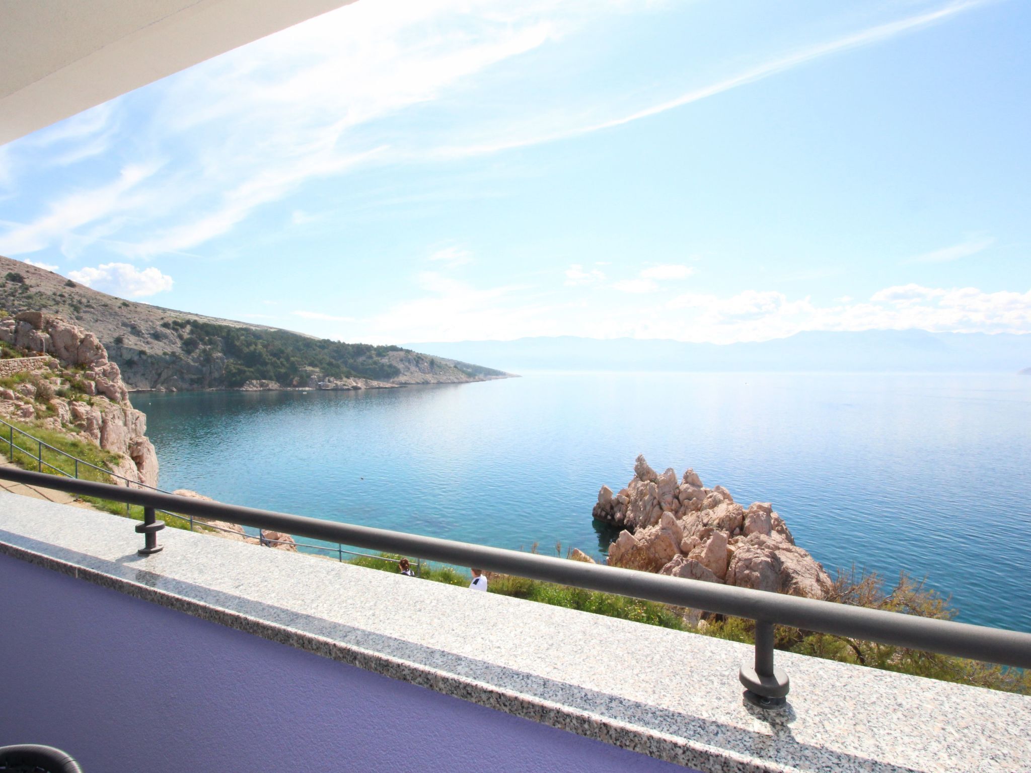 A scenic view of a coastal area with rocky cliffs and calm waters.