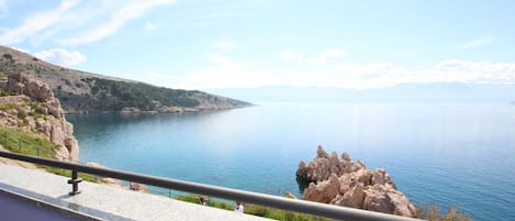 A scenic view of a coastal area with rocky cliffs and calm waters.