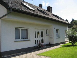 A single-story house with a white exterior, a dark roof, and a small front garden. - in der Vulkaneifel by Interhome (Ulmen)