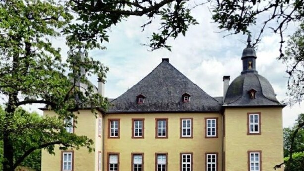 A large, yellow building with multiple windows and a prominent tower. - Haus-Fernblick by Interhome (Mechernich)