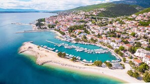 An aerial view of a coastal town with a marina, sandy beaches, and residential buildings. - Studio-Wohnung in Crikvenica by Interhome (Crikvenica)