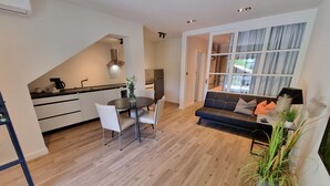 A modern living space with a dining area, a sofa, and a kitchen. - VIL Studio-Wohnung in Crikvenica, Kvarner Bucht by Interhome (Crikvenica)