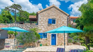 A stone building with a pool, outdoor seating, and a staircase leading to a balcony. - Ferienvilla Ivanka in Crikvenica by Interhome (Crikvenica)