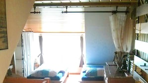 A compact, well-lit room with a loft bed, a small desk, and a chair. There is a window with curtains, a wooden floor, and a rug. - Ferien-Apartment  1 by Interhome (Blankenheim)