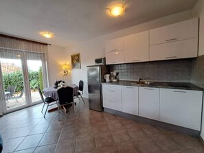 Fridge, microwave, cookware/dishes/utensils - "Nette App in der Nähe des Pools" by Interhome (Krk/Milohnići)