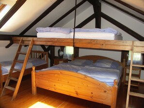 A loft bedroom with a wooden bunk bed, a wooden ladder, and a small wooden chair. - Altes Bauernhaus by Interhome (Kollnburg)