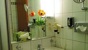 A bathroom with a sink, mirror, and toiletries. - Dream Apartment by Interhome (Rötz)