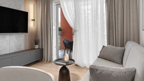A modern living room with a sofa, a coffee table, and a TV mounted on the wall. - Apartment Ana Makarska by Interhome (Makarska)
