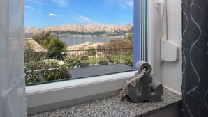 A balcony with a view of a lake and mountains. - Lavanda4 by Interhome (Krk/Baška)