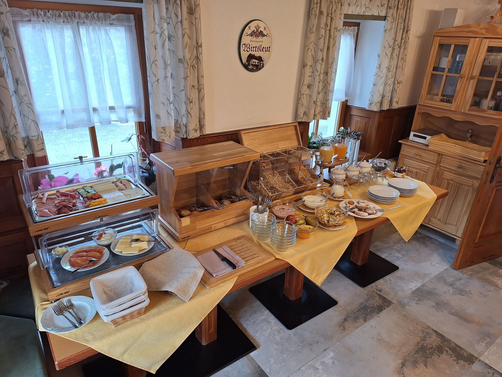 A breakfast buffet with various food items and a coffee station.