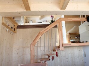 A wooden staircase with a wooden handrail and a glass door at the top. - Klippitzhimmel in Klippitztörl by Interhome (Bad St. Leonhard im Lavanttal)