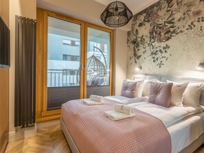 A bedroom with a large bed, a view of the outside, and a decorative wall. - Tower 26 - Ihr Ferienappartement in Swinemünde by Interhome (Swinoujscie)