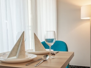 A neatly set dining table with a glass of water, a wine glass, and a fork and spoon. - in einzigartiger Lage auf Usedom by Interhome (Swinoujscie)