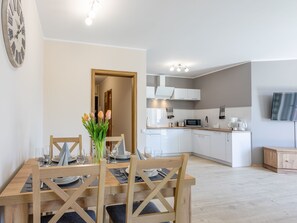 A modern kitchen with white cabinets, a microwave, and a coffee maker. - Zentrum an der Ostsee by Interhome (Swinoujscie)