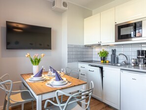A modern kitchen with white cabinets, a built-in microwave, and a dishwasher. - Ferienappartement Blue Rose direkt am Park by Interhome (Swinoujscie)