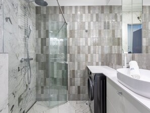 A modern bathroom with a glass-enclosed shower, a white sink, and a large mirror. - am Meer, Urlaub auf der Insel Usedom, Apartment 206 by Interhome (Swinoujscie)