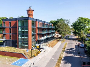 A modern building with a brick facade, large windows, and a tower. - Jachtowa mit Terrasse auf Usedom by Interhome (Swinoujscie)