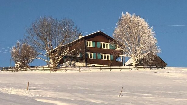 A two-story wooden house with a snow-covered landscape. - Neuer Sigerst by Interhome (Wildhaus)