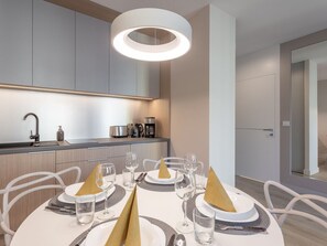 A modern kitchen with a built-in coffee maker, a kettle, and a toaster. - Schönes Ferienappartement Gold in Swinemünde by Interhome (Swinoujscie)