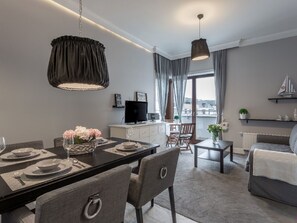 A modern living room with a dining area, a TV, and a balcony with a view. - Strandnahe Ferienwohnung Celeste by Interhome (Swinoujscie)