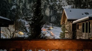 A wooden deck with heart-shaped decorations, a table with candles, and a snowy mountain view in the background. - Margrit West by Interhome (Lauterbrunnen)