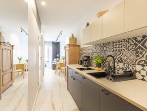 A modern kitchen with a marble floor, a sink, and a patterned backsplash. - Kormoran in modernem Appartementhaus by Interhome (Swinoujscie)