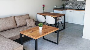 A modern kitchen with white cabinets, a microwave, and a patterned backsplash. - Haus 1 in Sarbinowo by Interhome (Sarbinowo)
