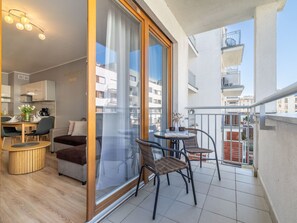 A modern apartment with a balcony, a dining area, and a living room. - Apartment Maja by Interhome (Swinoujscie)