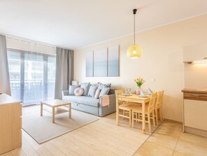 A modern apartment with a living room, dining area, and kitchen. - Charmante Ferienwohnung Sand auf Usedom by Interhome (Swinoujscie)