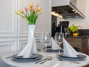 A dining table set with plates, glasses, and a vase of tulips. - Lividus in Usedom am Meer by Interhome (Swinoujscie)