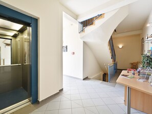 A hotel lobby with a staircase, a reception desk, and a view of the upper floor. - Villa Celia Sellin by Interhome (Ostseebad Sellin)
