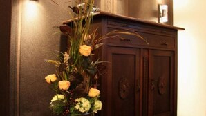 A wooden cabinet with a vase of flowers in front. - Designerwohnung in denkmalgeschütztem Wasserturm by Interhome (Güstrow)