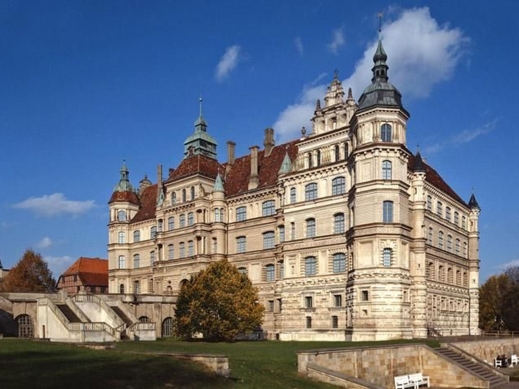 A large, historic building with multiple towers and a symmetrical facade, likely a government or cultural institution.