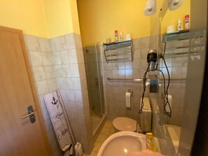 A bathroom with a glass shower enclosure, a toilet, a sink, and a towel rack. - L2 Sackgasse/Garten/Zaun/Carport by Interhome (Burhave)