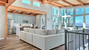 A modern kitchen with light blue cabinets, stainless steel appliances, and a large island. - Skyline Ridge | Modern New Build with Long Range Blue Ridge Mountain Views in Arden (Arden)