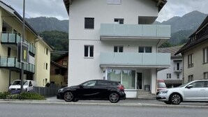A two-story building with a flat roof and a balcony on the second floor. - Appartement mit privatem Parkplatz by Interhome (Unterterzen)