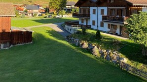 A rural mountain village with traditional wooden houses, a clear sky, and a lush green landscape. - Tscheppa B by Interhome (Camischolas)
