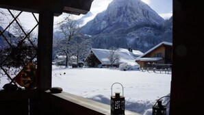 A snowy mountain landscape with a cabin and a wooden structure in the foreground. - Darioli by Interhome (Innertkirchen)