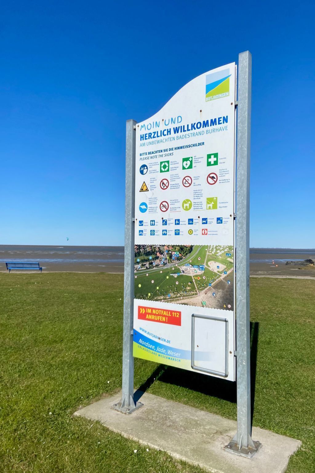 A sign with a map and various symbols indicating amenities and rules for visitors.