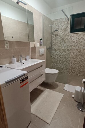 A modern bathroom with a shower, toilet, and sink area. - Jacuzzi Haus by Interhome (Posedarje)