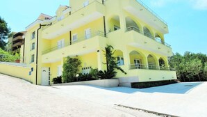 A multi-story yellow building with balconies and a swimming pool. - Apartment Luna by Interhome (Trogir/Okrug Donji)