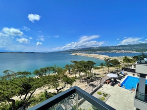 A pool area with a view of the sea and a beach. - Apartment Punta Silo by Interhome (Krk/Šilo)