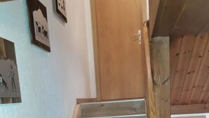 A wooden staircase with a handrail, leading to a door. - auf dem Bauernhof by Interhome (Lütisburg Station)