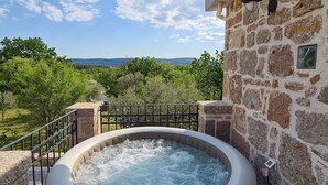 A hot tub with a stone wall and a view of trees and hills. - Altes Steinhaus Goranova Kuca by Interhome (Starigrad-Paklenica)